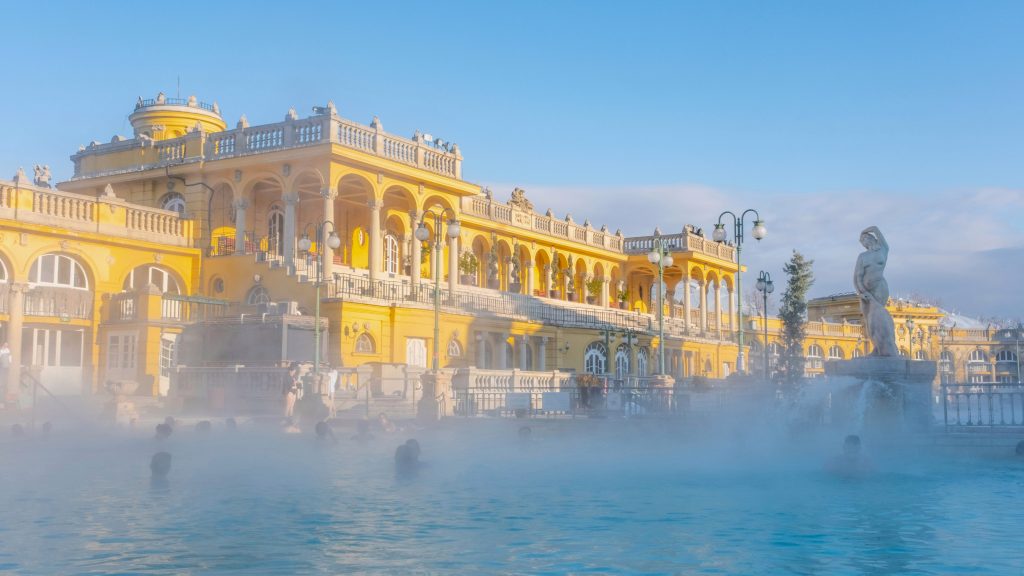 Széchenyi Baths : Budapest Hungary yellow baroque building with outdoor swimming pools