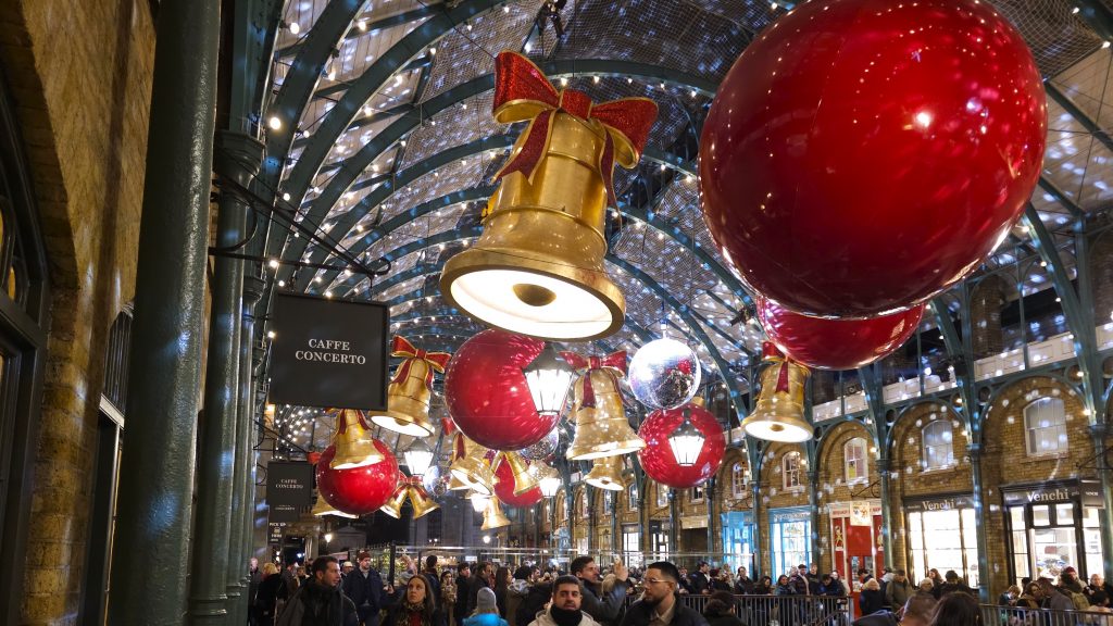 Best place to see xmas lights in London, Covent Garden with large baubles and bells suspended from the ceiling