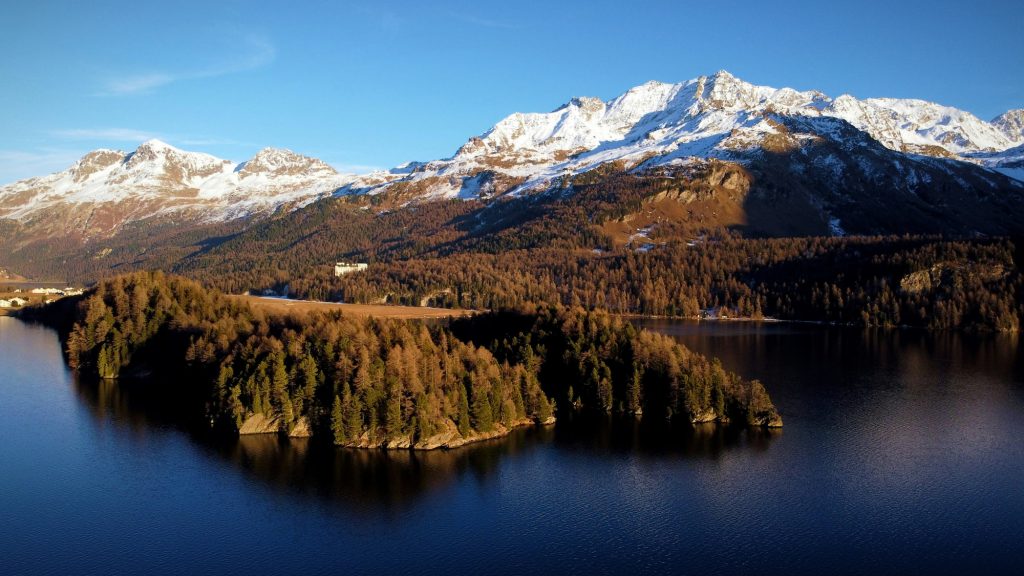 Engadin, Switzerland.  View of a lake and the mountains behind. one of the best places to go in Europe in June